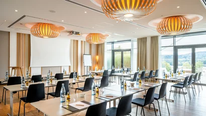 Modernes Tagungszimmer mit Tischen, Stühlen und Flüssigkeiten vorbereitet